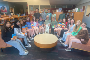 Students posing in the library with author Joseph Wallace 